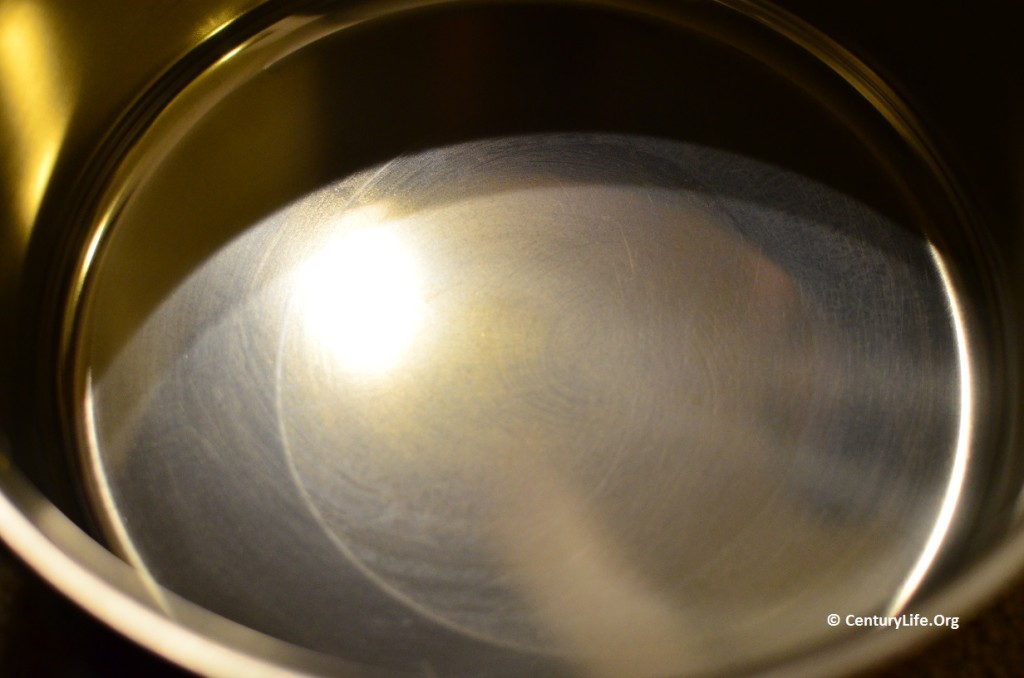 The bottom of this new pot was heated by an uneven heating element. The tin that was exposed to temperatures above 322F softened. Even when the tin cooled down, it no longer looked pristine. The sides of the pot never reached softening temperatures, nor did a crescent-shaped portion of the bottom of the pot. (This pot was taken off the burner soon after the tin started to soften.)