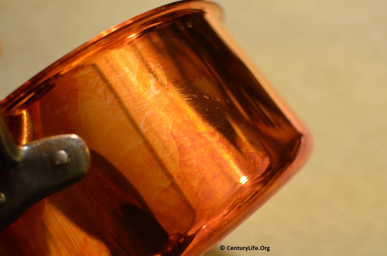 This copper pot has slightly oxidized into a golden/orange color.