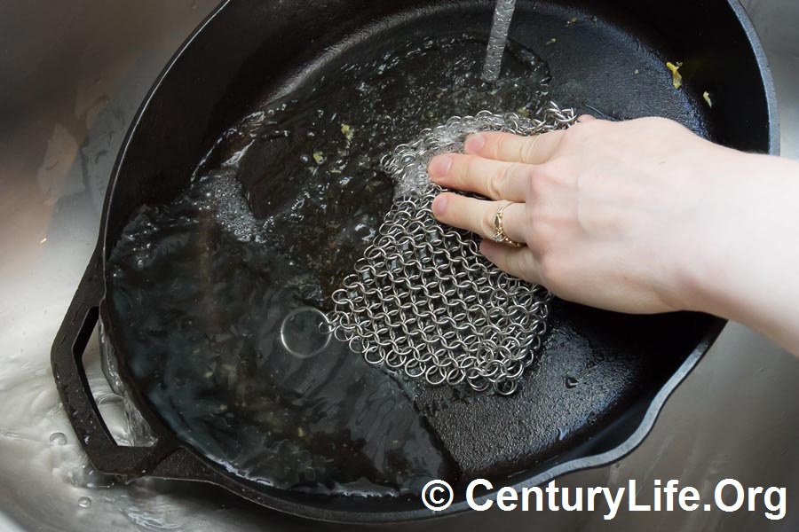 Hot water + chain mail is surprisingly effective at cleaning cast iron and carbon steel without damaging seasoning